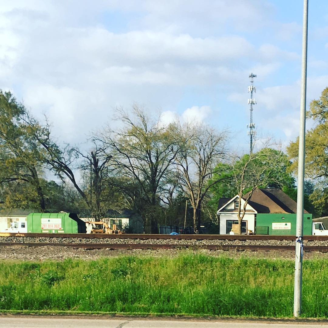 Small train station surrounded by trees